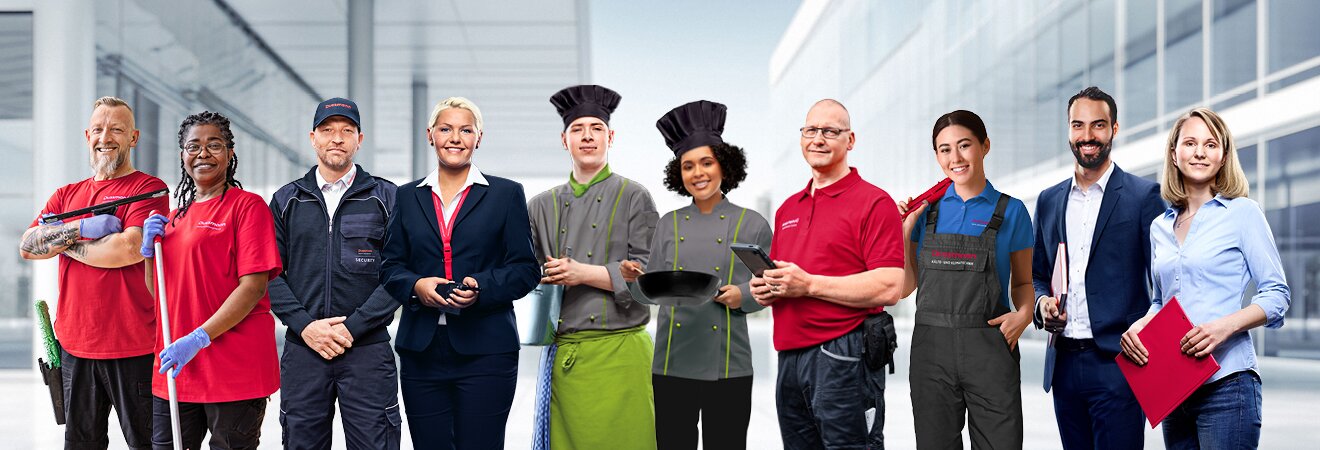 Careers at Dussmann: Discover a wide variety of jobs. Group picture of smiling Dussmann employees from different work areas in front of a gray background, wearing their work clothes.